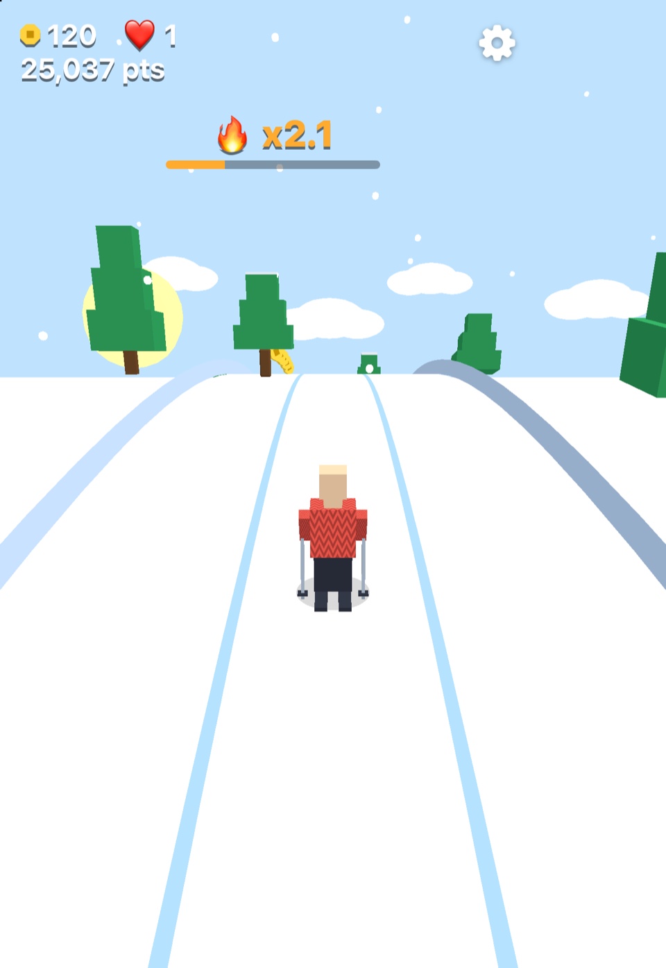 Alpine gameplay on iPhone Duo, with the Skier approaching trees and a trail of coins