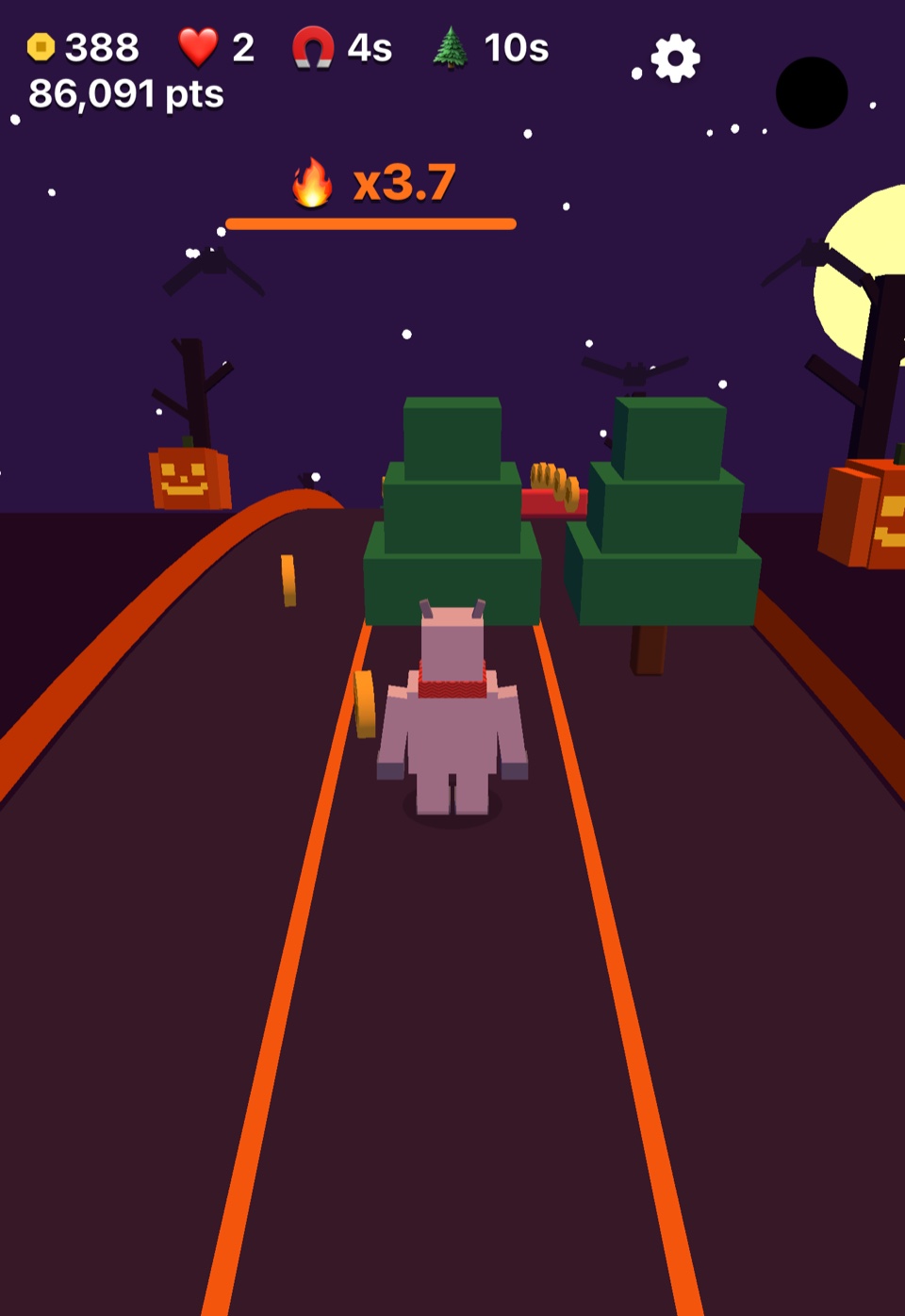 Haunted Hollow gameplay on iPhone Duo, with the Yeti, coins, trees, pumpkins, and bats